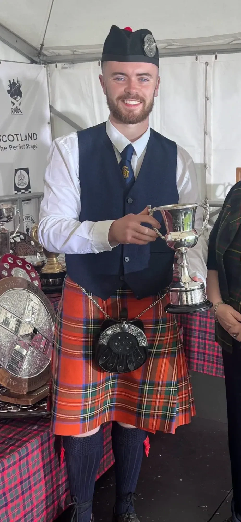 Thomas Rankine, Pipe Major, holding a trophy in band uniform